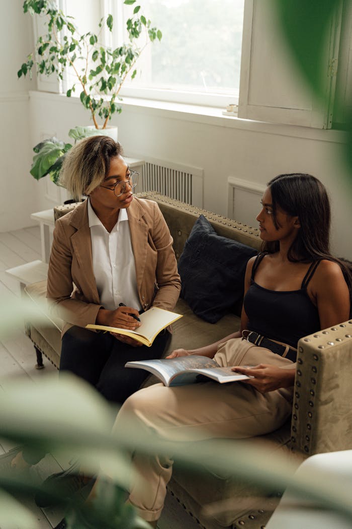 A mentor and student having a focused learning session in a bright indoor setting.