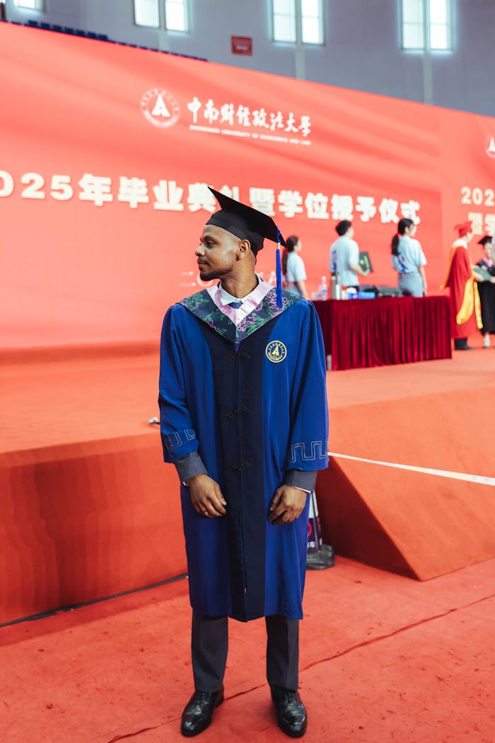 male-graduate-in-cap-and-gown-at-ceremony-32703391